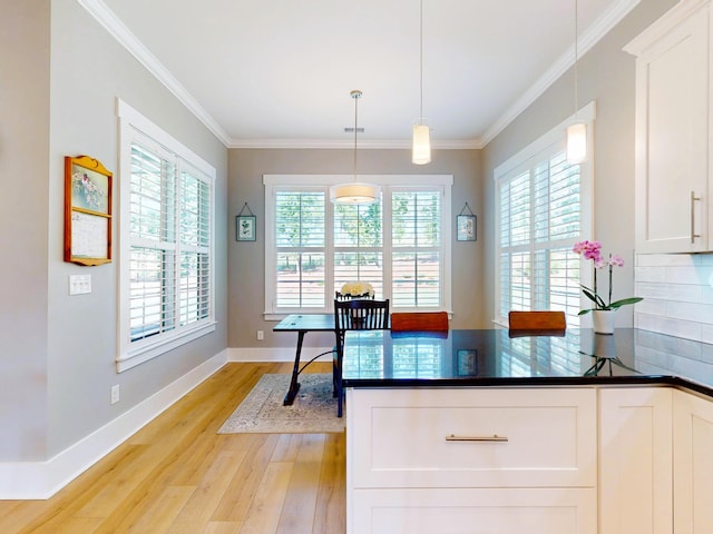 243 Walton Heath Way, Aiken, SC 29803 - kitchen with light wood-type flooring, white cabinets, ornamental molding, hanging light fixtures, and a peninsula