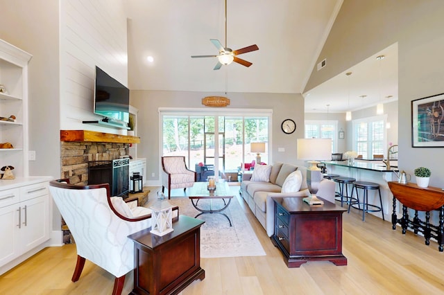 243 Walton Heath Way, Aiken, SC 29803 - living area with a ceiling fan, light wood-style floors, a stone fireplace, and high vaulted ceiling