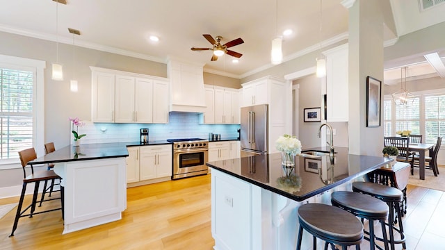243 Walton Heath Way, Aiken, SC 29803 - kitchen featuring premium appliances, a sink, a peninsula, dark countertops, and a ceiling fan