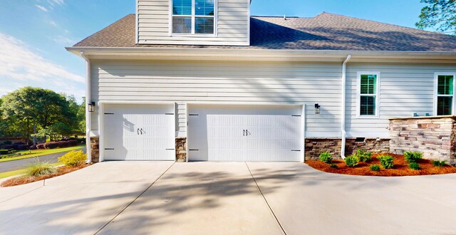243 Walton Heath Way, Aiken, SC 29803 - view of property exterior featuring concrete driveway, a shingled roof, stone siding, and an attached garage