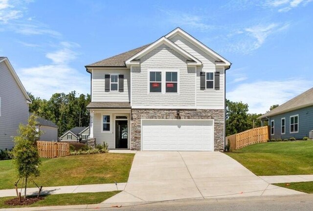 view of front of house with a front yard and a garage