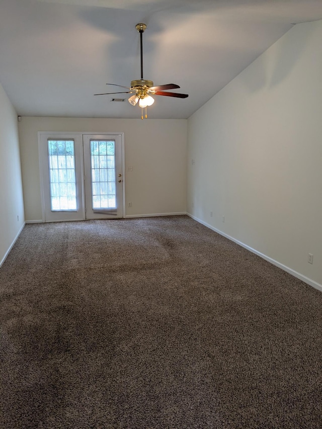unfurnished room featuring baseboards, ceiling fan, carpet floors, and vaulted ceiling