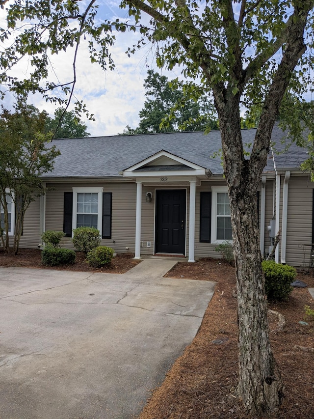 view of front of home with roof with shingles