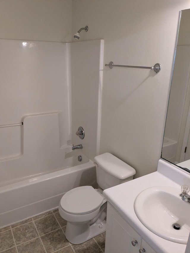 bathroom with toilet,  shower combination, and vanity