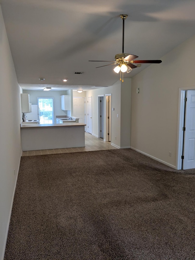 unfurnished living room featuring visible vents, a ceiling fan, and light carpet