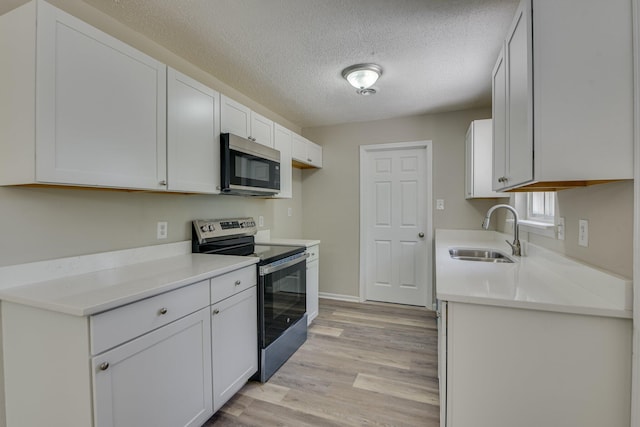 2206 Church Hill Ct, Augusta, GA 30906 - kitchen with light wood finished floors, light countertops, a sink, and appliances with stainless steel finishes