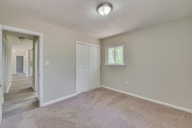 2206 Church Hill Ct, Augusta, GA 30906 - unfurnished bedroom featuring a closet, a textured ceiling, carpet flooring, and baseboards