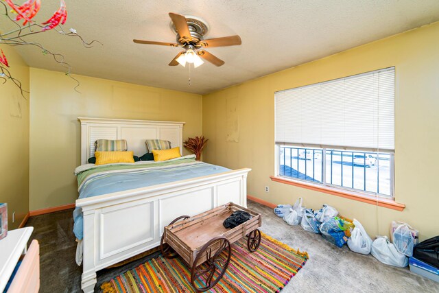 carpeted bedroom featuring ceiling fan and a textured ceiling