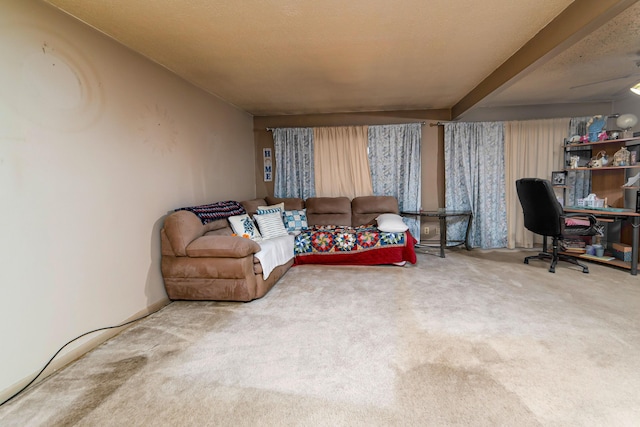 living room with carpet flooring, ceiling fan, and a textured ceiling