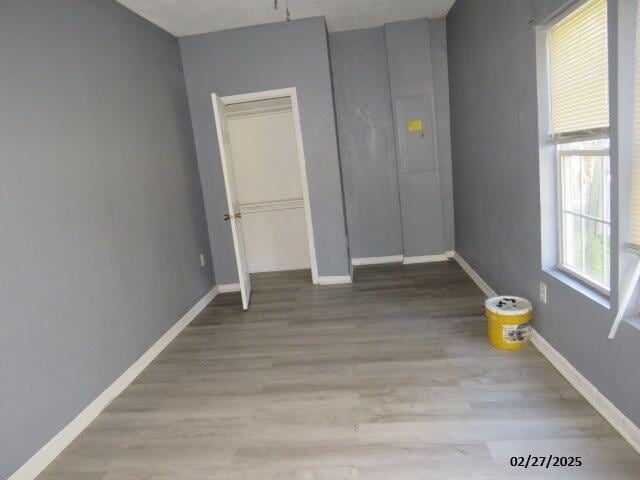 unfurnished bedroom with baseboards and wood finished floors