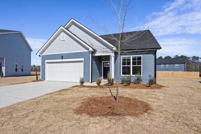 view of front of home featuring board and batten siding, fence, driveway, and an attached garage