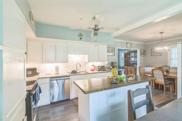2917 Westchester Ct, Augusta, GA 30909 - kitchen with appliances with stainless steel finishes, light wood finished floors, white cabinets, and ornamental molding