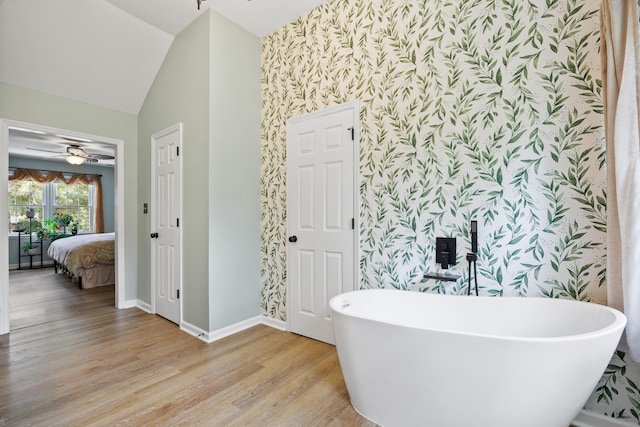 534 Creekridge Rd, Aiken, SC 29803 - full bath with wallpapered walls, a freestanding tub, wood finished floors, vaulted ceiling, and ceiling fan