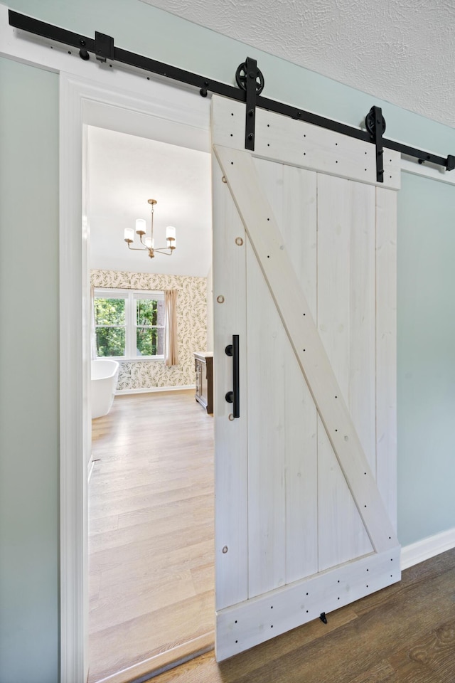 534 Creekridge Rd, Aiken, SC 29803 - detailed view of a barn door, wood finished floors, and a chandelier