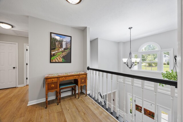 534 Creekridge Rd, Aiken, SC 29803 - corridor with wood finished floors, a chandelier, and an upstairs landing