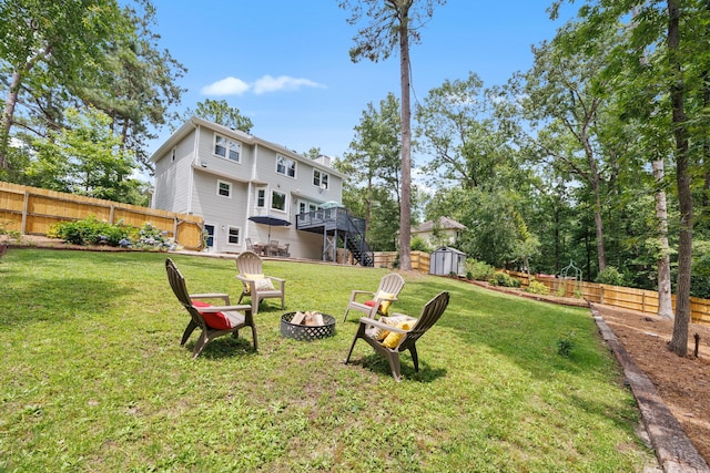534 Creekridge Rd, Aiken, SC 29803 - fenced backyard featuring a fire pit, stairway, a storage shed, and a wooden deck
