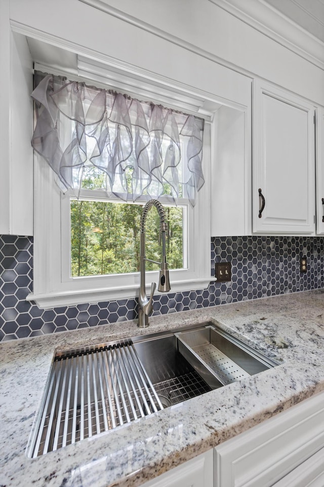 534 Creekridge Rd, Aiken, SC 29803 - kitchen view of backsplash, white cabinetry, and light stone countertops