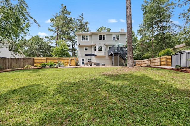 534 Creekridge Rd, Aiken, SC 29803 - back of house featuring a fenced backyard, a storage shed, a wooden deck, stairs, and a chimney