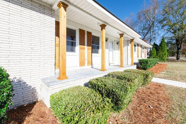 view of exterior entry with covered porch