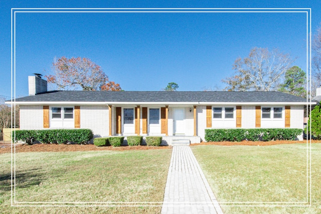 ranch-style home with a front lawn