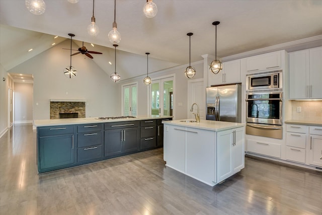 525 Brigham Trl, Augusta, GA 30909 - kitchen with appliances with stainless steel finishes, a warming drawer, an island with sink, a ceiling fan, and light countertops