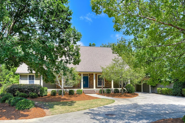 525 Brigham Trl, Augusta, GA 30909 - view of property hidden behind natural elements featuring roof with shingles, driveway, and a porch