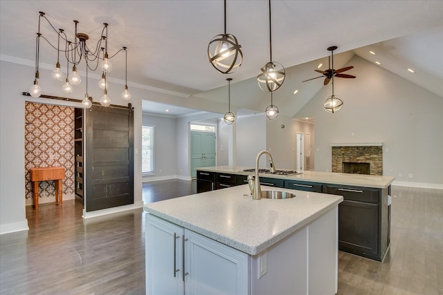 525 Brigham Trl, Augusta, GA 30909 - kitchen featuring a center island with sink, open floor plan, light wood-style floors, a barn door, and ceiling fan