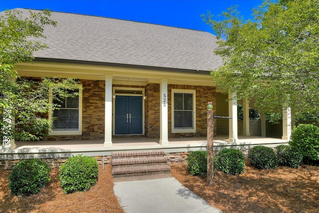 525 Brigham Trl, Augusta, GA 30909 - view of exterior entry featuring covered porch, roof with shingles, and stone siding