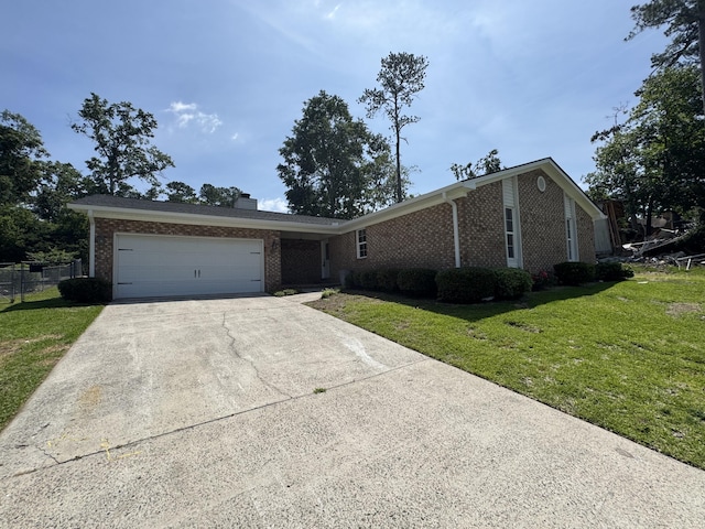 3112 Fieldstone Cir, Augusta, GA 30907 - view of front facade featuring brick siding, concrete driveway, a garage, and a chimney