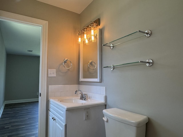 3112 Fieldstone Cir, Augusta, GA 30907 - bathroom with vanity, toilet, wood finished floors, and baseboards