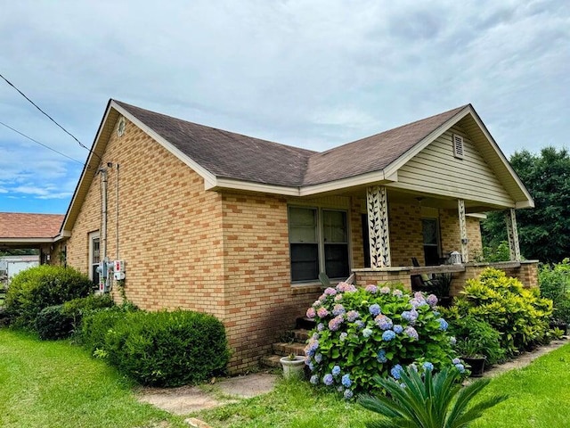 289 Cathy Dr, Warrenville, SC 29851 - view of home's exterior featuring brick siding, a porch, and roof with shingles