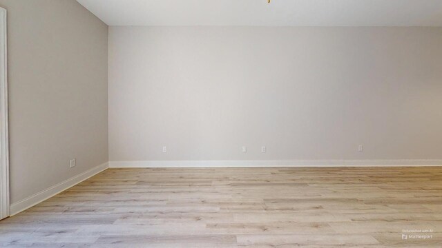 unfurnished living room featuring ceiling fan with notable chandelier and light hardwood / wood-style flooring