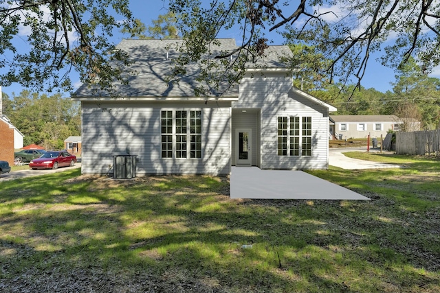 rear view of house featuring a patio area and a lawn