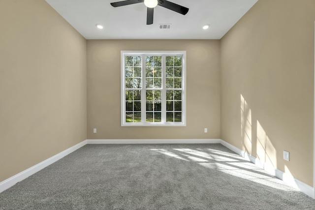 unfurnished room with ceiling fan and carpet