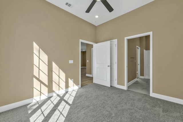 unfurnished bedroom featuring ceiling fan, light colored carpet, and a closet