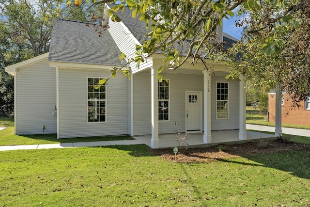 back of property with a lawn