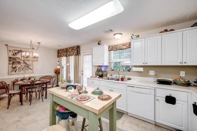 543 Cranberry Cir, Grovetown, GA 30813 - kitchen with white dishwasher, a sink, light countertops, a textured ceiling, and white cabinetry