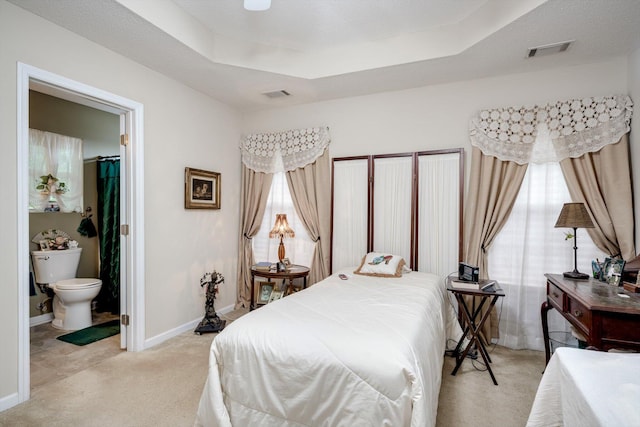 543 Cranberry Cir, Grovetown, GA 30813 - bedroom featuring light colored carpet, baseboards, a raised ceiling, and connected bathroom