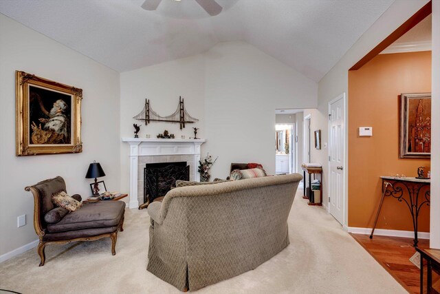 543 Cranberry Cir, Grovetown, GA 30813 - living room with ceiling fan, a tiled fireplace, vaulted ceiling, and baseboards