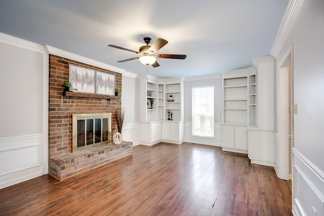 123 Sugar Maple Ln, Martinez, GA 30907 - unfurnished living room featuring ceiling fan, a fireplace, built in features, a decorative wall, and wood finished floors