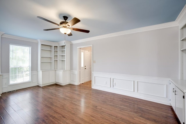 123 Sugar Maple Ln, Martinez, GA 30907 - empty room featuring a ceiling fan, ornamental molding, dark wood-style floors, wainscoting, and a decorative wall
