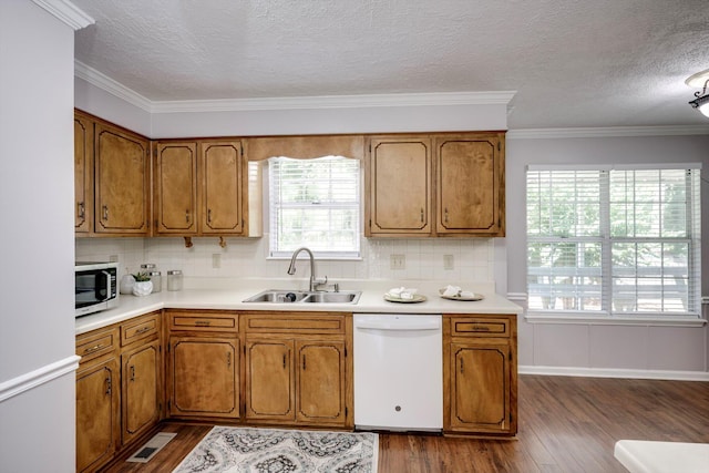 123 Sugar Maple Ln, Martinez, GA 30907 - kitchen featuring dishwasher, stainless steel microwave, brown cabinets, dark wood-style floors, and backsplash
