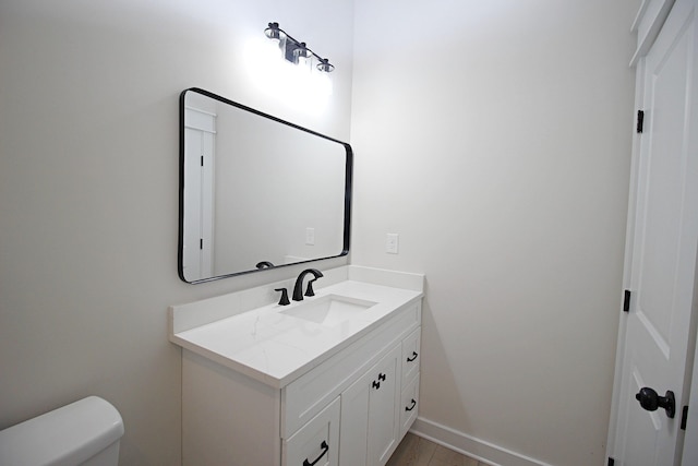 bathroom with toilet and vanity