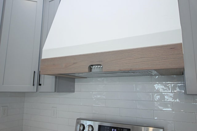 room details featuring stove and custom range hood