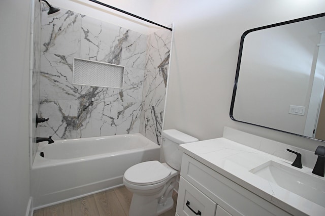 full bathroom with toilet, vanity, tiled shower / bath, and hardwood / wood-style floors