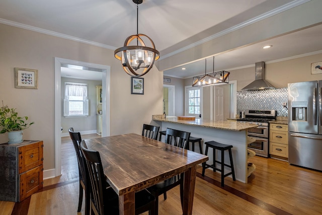 3011 Fox Spring Rd, Augusta, GA 30909 - dining room with a chandelier, light wood-style flooring, and crown molding