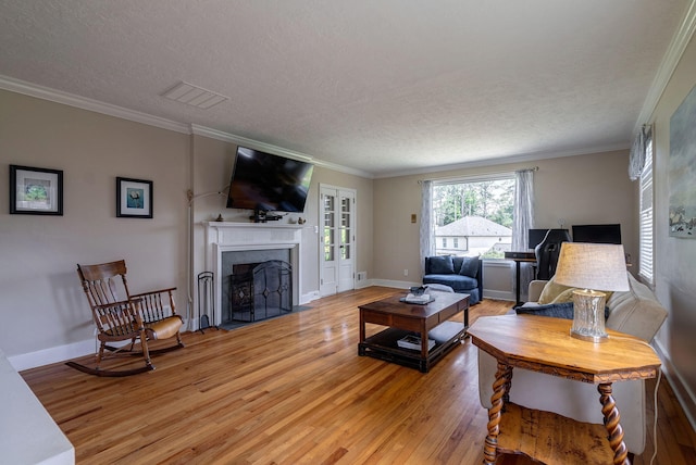 3011 Fox Spring Rd, Augusta, GA 30909 - living area with light wood-style flooring, a fireplace with flush hearth, a textured ceiling, and ornamental molding