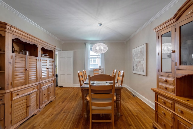 3011 Fox Spring Rd, Augusta, GA 30909 - dining room featuring light wood-style flooring, a chandelier, and crown molding