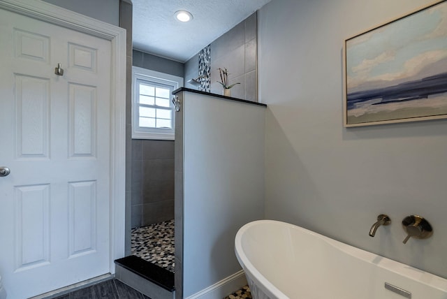 3011 Fox Spring Rd, Augusta, GA 30909 - bathroom featuring a soaking tub, a walk in shower, and a textured ceiling