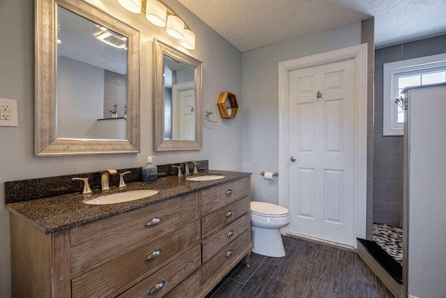 3011 Fox Spring Rd, Augusta, GA 30909 - bathroom featuring double vanity, a tile shower, and wood finished floors